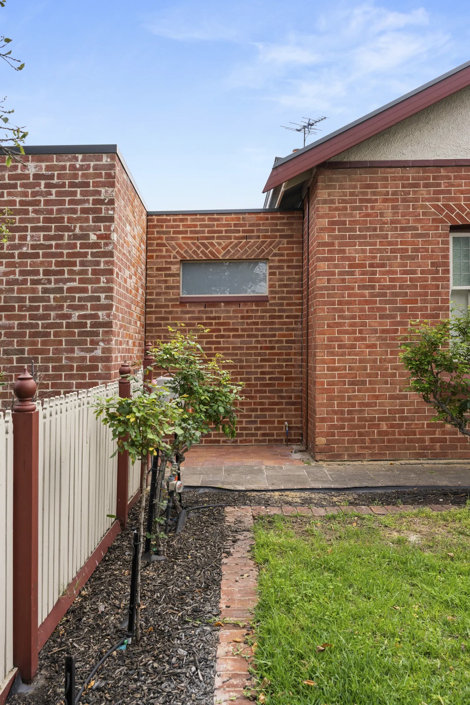 New brickwork meeting the original red brick home
