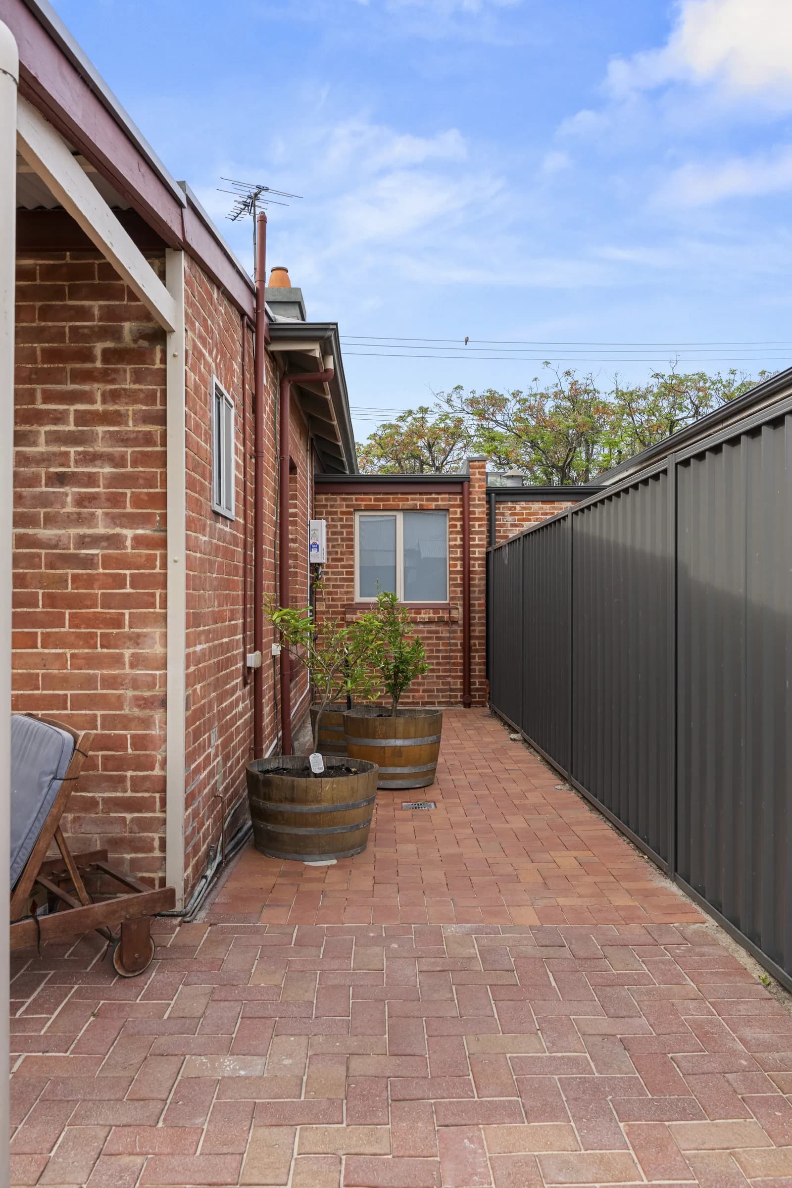 Paved side courtyard beside the brick home